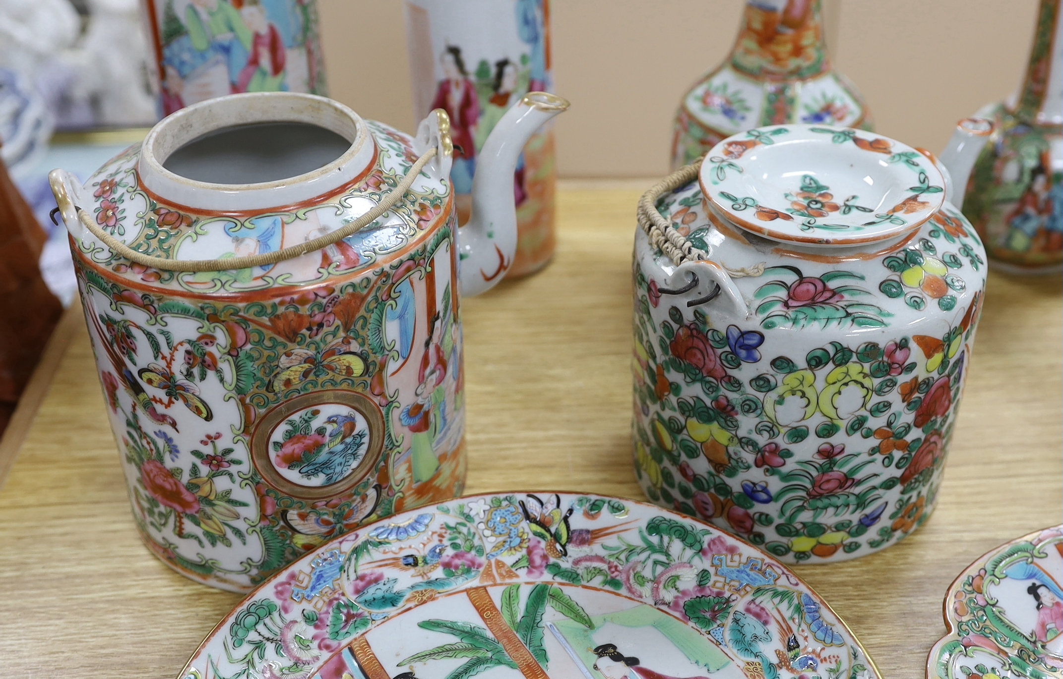 A quantity of 19th century Chinese famille rose dishes, plates, teapots and vases, tallest 21.5cm